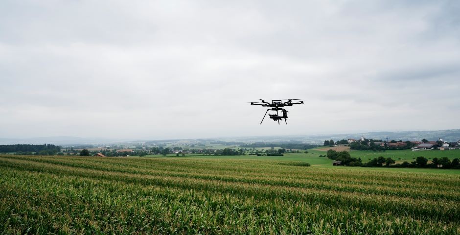 Drone flies over field